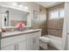 Well-lit bathroom featuring a double sink vanity, tiled shower, and updated fixtures at 13542 Achilles Dr, Lone Tree, CO 80124