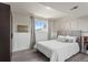 Charming bedroom features a comfortable bed, wood-look floors and a bright window at 13542 Achilles Dr, Lone Tree, CO 80124