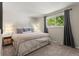 Cozy bedroom featuring a neutral color scheme, plush carpet, and large window at 13542 Achilles Dr, Lone Tree, CO 80124