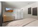 Serene bedroom with ample closet space, soft lighting, and a mounted flatscreen television at 13542 Achilles Dr, Lone Tree, CO 80124