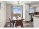 Cozy dining area with a view of the backyard, seamlessly connected to the kitchen at 13542 Achilles Dr, Lone Tree, CO 80124