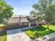 Aerial view of a home with a well-manicured lawn and mature trees in a suburban neighborhood at 13542 Achilles Dr, Lone Tree, CO 80124
