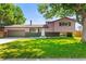 Charming two-story home with well-maintained lawn, mature trees, and inviting curb appeal at 13542 Achilles Dr, Lone Tree, CO 80124