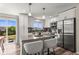 Stylish kitchen with stainless steel appliances, center island, and sleek white cabinetry at 13542 Achilles Dr, Lone Tree, CO 80124