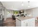 Open-concept living area with fireplace, modern kitchen island, and comfortable seating at 13542 Achilles Dr, Lone Tree, CO 80124