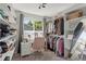 Organized walk-in closet with shelving, clothing racks, a window, and a vanity desk at 13542 Achilles Dr, Lone Tree, CO 80124