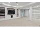 Finished basement with built-in shelving and media area plus sliding glass doors to the backyard at 6534 S Union Way, Littleton, CO 80127