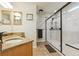 Bathroom featuring glass enclosed shower with tile surround and double vanity with stone countertop at 6534 S Union Way, Littleton, CO 80127