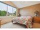 Bedroom featuring a large window with neighborhood views and a cozy floral bedspread at 6534 S Union Way, Littleton, CO 80127