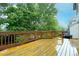 View of wooden deck overlooking lush green yard space with blue sky and trees in the background at 6534 S Union Way, Littleton, CO 80127