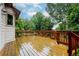 Wooden deck overlooking lush green yard space with blue sky and trees in the background at 6534 S Union Way, Littleton, CO 80127