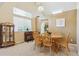 Comfortable dining space with vaulted ceilings, piano, and views into kitchen at 6534 S Union Way, Littleton, CO 80127