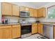 Functional kitchen featuring stainless steel appliances, wood cabinets, and granite countertops at 6534 S Union Way, Littleton, CO 80127
