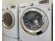Laundry area featuring modern, front-load washer and dryer with chrome accents at 6534 S Union Way, Littleton, CO 80127