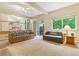 Cozy living room with carpet, ceiling fan and natural light from the sliding glass doors leading to the deck at 6534 S Union Way, Littleton, CO 80127