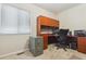 Well-lit office space with built-in desk, cabinetry, and a neutral color palette at 6534 S Union Way, Littleton, CO 80127