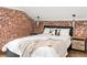 Cozy bedroom featuring an exposed brick wall and comfortable furnishings at 2715 W 37Th Ave, Denver, CO 80211