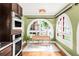 Bright breakfast nook offers large arched windows, hardwood floors, and stylish lighting at 2715 W 37Th Ave, Denver, CO 80211