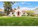 Inviting home exterior with a large green lawn, mature trees, and a red brick accented facade at 2715 W 37Th Ave, Denver, CO 80211