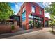 Charming red brick building with black accents, featuring outdoor seating and large windows at 2715 W 37Th Ave, Denver, CO 80211