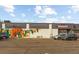 Wide angle shot featuring storefront with local mural, well-maintained parking lot and customer parking at 2715 W 37Th Ave, Denver, CO 80211