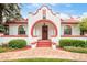 Charming front entrance with red brick accents, a red front door and manicured landscaping at 2715 W 37Th Ave, Denver, CO 80211