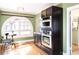 Modern kitchen with updated appliances, a charming breakfast nook, and unique arch window at 2715 W 37Th Ave, Denver, CO 80211