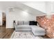 Cozy living room area with exposed brick accent wall at 2715 W 37Th Ave, Denver, CO 80211