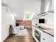 Bright living area with exposed brick wall, modern decor and hardwood floors at 2715 W 37Th Ave, Denver, CO 80211
