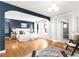 Spacious main bedroom with blue accent wall, hardwood floors, and ample natural light at 2715 W 37Th Ave, Denver, CO 80211