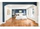 Bright main bedroom showcases a blue accent wall, hardwood floors, and large windows at 2715 W 37Th Ave, Denver, CO 80211