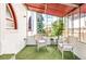 Bright sunroom featuring comfortable seating and lush outdoor views through large windows at 2715 W 37Th Ave, Denver, CO 80211