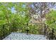 Balcony with ornate iron railings and patterned tile flooring overlooking mature trees at 458 Adams St, Denver, CO 80206