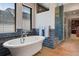 Charming bathroom with soaking tub, luxurious tile surround, and separate glass shower at 458 Adams St, Denver, CO 80206