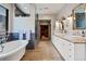 Bright bathroom featuring a soaking tub, double vanity with designer sinks, and a walk in shower at 458 Adams St, Denver, CO 80206