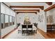 Elegant dining room with wood beams, chandelier lighting, and a large window at 458 Adams St, Denver, CO 80206