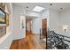 Upper hallway boasts hardwood floors, curved walls, skylight, and wrought iron railing, complemented by recessed lighting at 458 Adams St, Denver, CO 80206