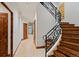 Hallway with a staircase, iron railing, and multiple doors leading to various rooms at 458 Adams St, Denver, CO 80206