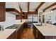 Gourmet kitchen featuring stainless steel appliances, custom cabinets, and a large island with stone countertops at 458 Adams St, Denver, CO 80206