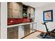 Finished basement kitchenette with red backsplash, stainless steel appliances, and custom cabinets at 458 Adams St, Denver, CO 80206