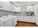 Bright laundry room featuring modern washer and dryer with ample cabinet storage and tile backsplash at 458 Adams St, Denver, CO 80206