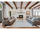 Inviting living room features exposed beams, a cozy fireplace, and neutral decor at 458 Adams St, Denver, CO 80206