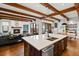 Inviting living room with exposed beams, a cozy fireplace, and an open layout connecting to the dining area at 458 Adams St, Denver, CO 80206