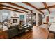 Cozy living room with a fireplace, exposed beams, and large windows offering natural light and a welcoming ambiance at 458 Adams St, Denver, CO 80206