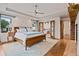 Spacious main bedroom featuring hardwood floors, ceiling fan, and access to the en-suite bathroom, offering comfort and privacy at 458 Adams St, Denver, CO 80206
