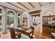 Charming home office with wood beams, hardwood floors, and a large arched window at 458 Adams St, Denver, CO 80206