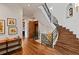Grand staircase with wrought iron railing and hardwood floors at 458 Adams St, Denver, CO 80206
