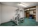 Finished basement with home gym and shelving at 8015 W Calhoun Pl, Littleton, CO 80123