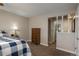 Spacious bedroom with ensuite bathroom access and a dresser at 8015 W Calhoun Pl, Littleton, CO 80123