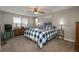 Comfortable bedroom with a ceiling fan and large window at 8015 W Calhoun Pl, Littleton, CO 80123